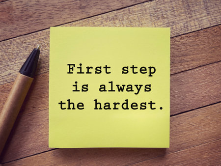 Motivational and inspirational wording. First Step Is Always The Hardest written on a notepad. With...