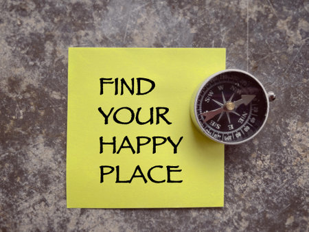 Motivational and inspirational wording. FIND YOUR HAPPY PLACE written on a note paper. With blurred styled background.の写真素材
