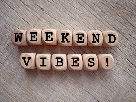 Motivational and inspirational wording. WEEKEND VIBES written on wooden blocks. With blurred styled background.の写真素材