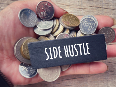 Self income and economic stability concept. SIDE HUSTLE written on a wooden block. With blurred...