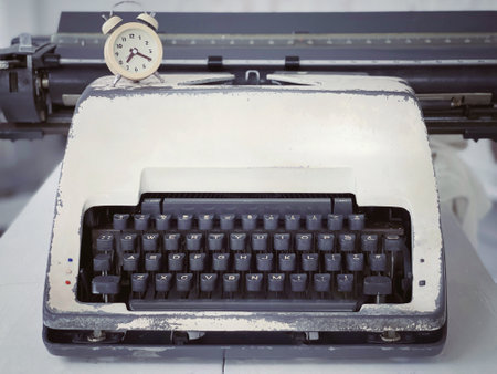Technology and communication concept. Front view of a vintage typewriter with blurred vintage styled background.の写真素材