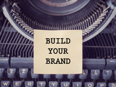 Business and management concept. BUILD YOUR BRAND written on a paper. With blurred style background.