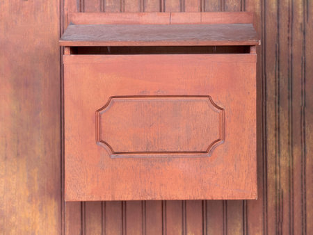 Technology and communication concept. A wooden letter box mountedto a wall of an old building.の写真素材