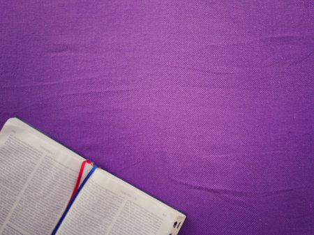 Christianity concept about church Liturgy, Ash Wednesday, Good Friday, Lent Season and Holy Week. A holy bible arranged on purple background, blurred.の写真素材