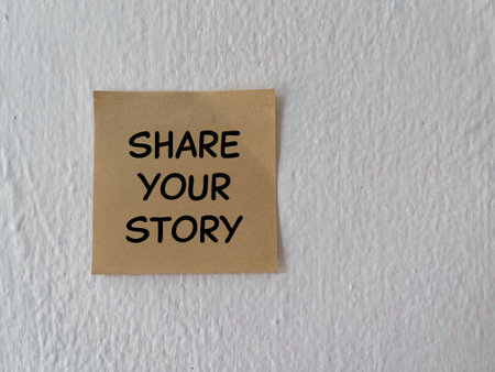 Motivational and inspirational wording. SHARE YOUR STORY written on a paper. On white background.の写真素材