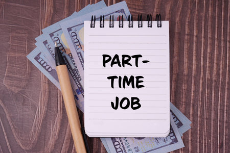 Job and financial management. PART TIME JOB written on a notepad. With blurred styled background.の写真素材