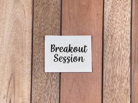 Job and management concept. BREAKOUT SESSION written on adhesive paper. On blurred white background.の写真素材