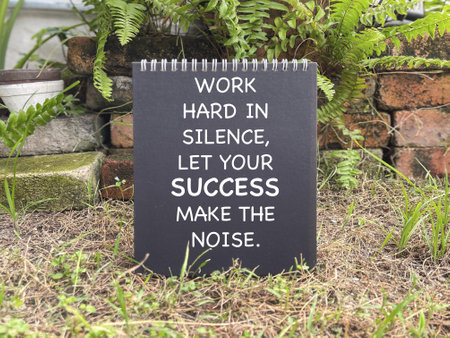 Motivational and inspirational wording. WORK HARD IN SILENCE, LET YOUR SUCCESS MAKE THE NOISE written on a notepad.の写真素材