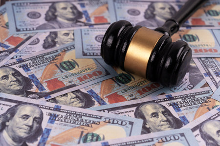 Wooden judge gavel on dollar banknotes backgroundの写真素材