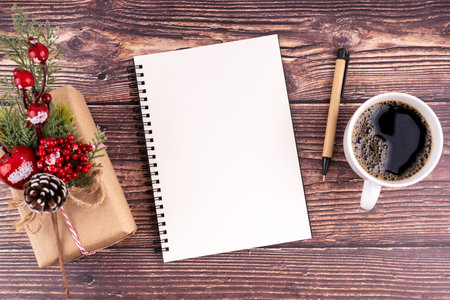 Christmas decorations and empty notebook for copy space on wooden background.の写真素材