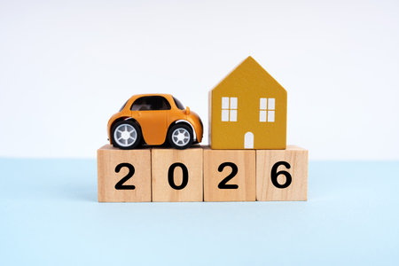 2026 written on wood blocks with mini car and house model. New Year plan conceptの写真素材