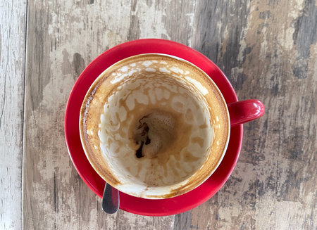 Flat lay of empty mocha drink cup on wooden tableの写真素材