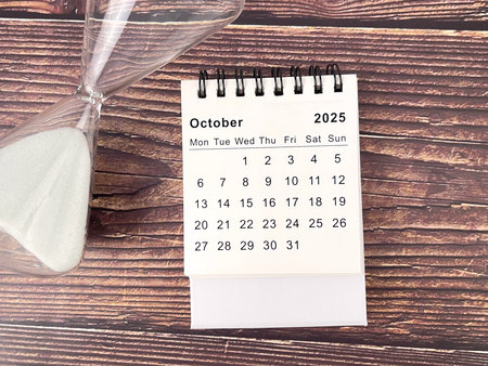 2025 October desk calendar flat lay on wooden tableの写真素材