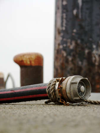 water hose on pier in harborの写真素材