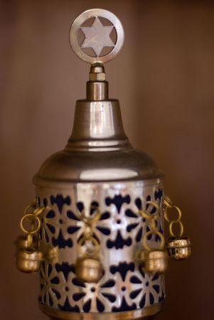 Close up shot of the crown that protects the handles of a Torah scroll while not in use.  Decorated with a star of David and bells.の写真素材