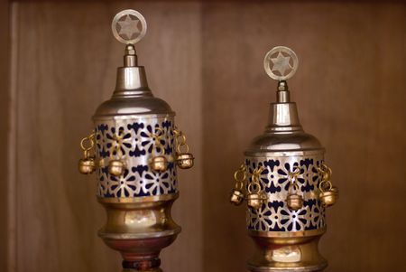 Close up shot of the crown that protects the handles of a Torah scroll while not in use.  Decorated with a star of David and bells.の写真素材