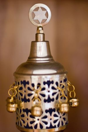 Close up shot of the crown that protects the handles of a Torah scroll while not in use.  Decorated with a star of David and bells.の写真素材