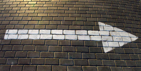  image of pointer  with an arrow painted on the roadの写真素材