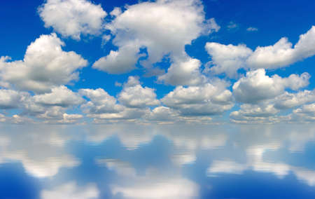 image of blue sky with clouds reflected in the waterの写真素材