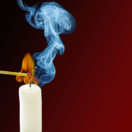 Smoke from a burning candle and matchesの写真素材