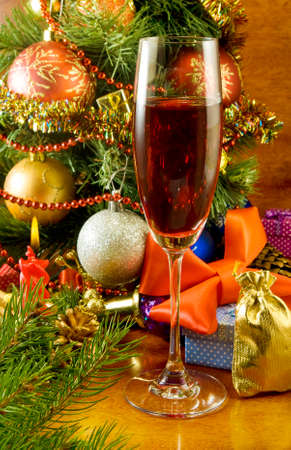 image of a Christmas tree, candle and glass of wineの写真素材