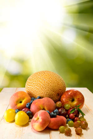 image of different fruits on sun backgroundの写真素材