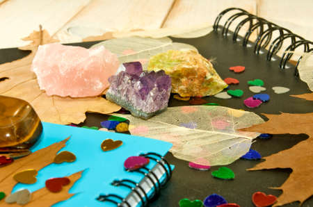notebooks, autumn leaves and stones closeup