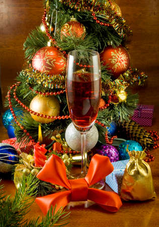 image of a Christmas tree, candle and glass of wineの写真素材