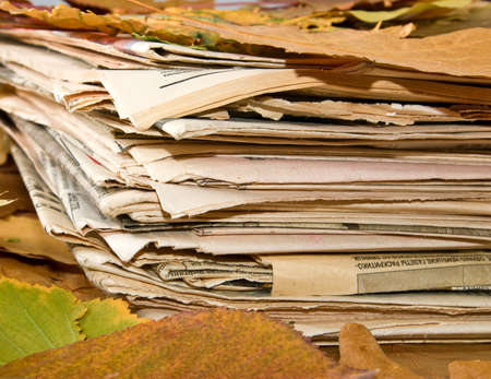 newspapers and autumn leavesの写真素材