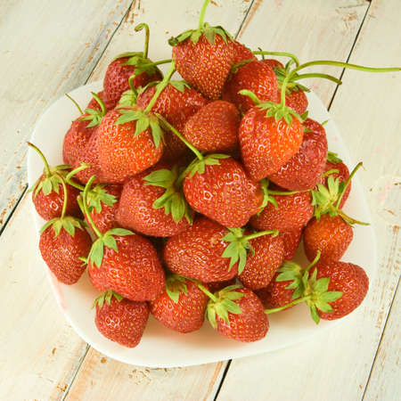 ripe and tasty strawberries on plate closeupの写真素材