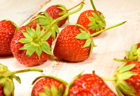 image of ripe and sweet strawberries on wooden table closeupの写真素材