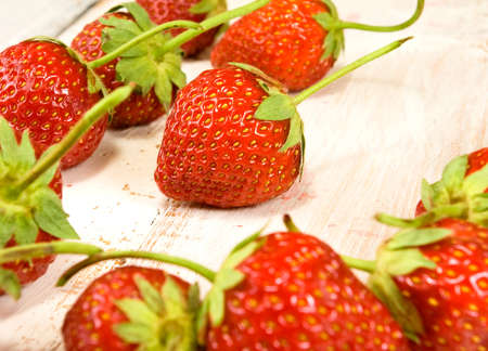 image of ripe and tasty strawberries on wooden table closeupの写真素材