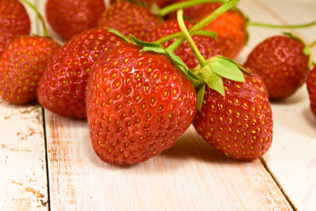 ripe and tasty strawberries on wooden table closeupの写真素材
