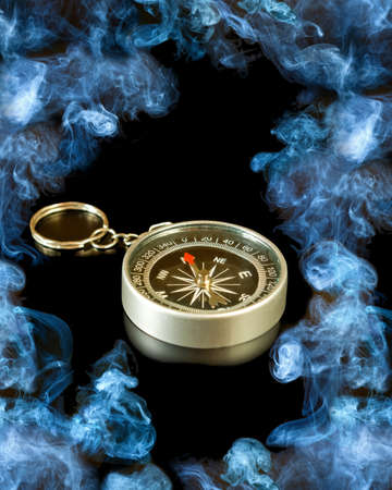 image of a compass on smoke backgroundの写真素材
