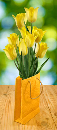 flowers in gift packing on a green backgroundの写真素材