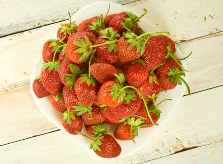 ripe and sweet strawberries on plate closeupの写真素材