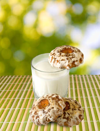 image of milk and cookies on a green backgroundの写真素材