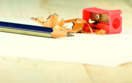 pencil sharpener, pencil and shavings on white background closeup