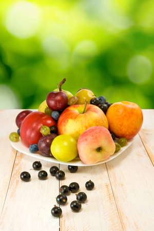 ripe fruits on a plate on a blurred backgroundの写真素材