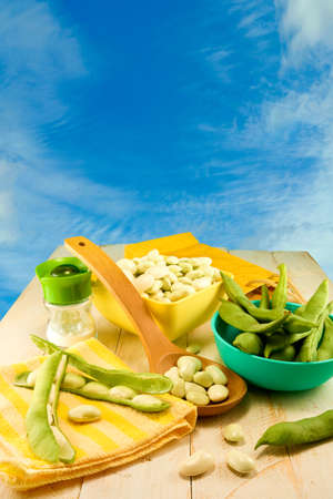 young beans in pods on the table on blue background closeの写真素材