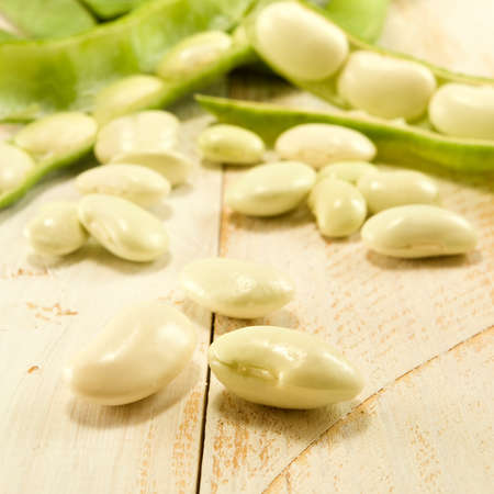 beans in pods on a wooden tableの写真素材
