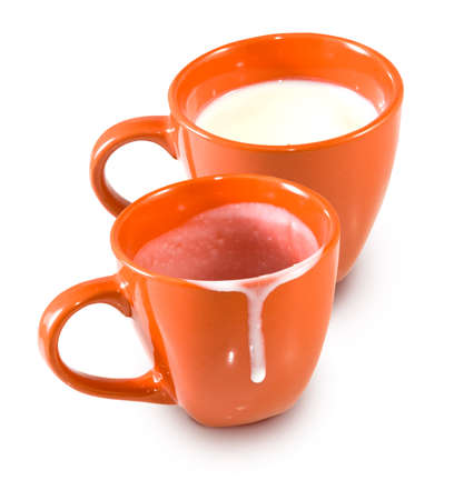 image of an empty cup and a cup of milkの写真素材