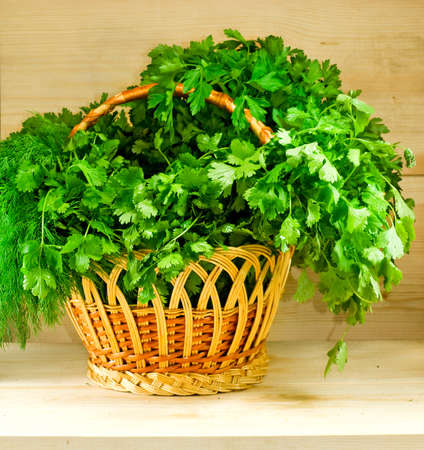 Image of different herbs in a basket on the tableの写真素材