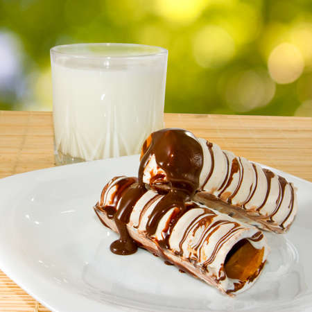 image of a glass with milk and chocolate tubulesの写真素材