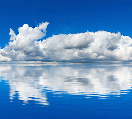 image of blue sky with clouds reflected in the waterの写真素材