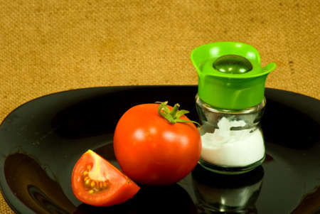 image of tomato and salt on the plate closeupの写真素材