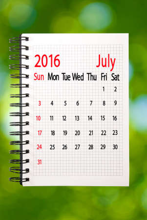 calendar for the month of July on a green backgroundの写真素材