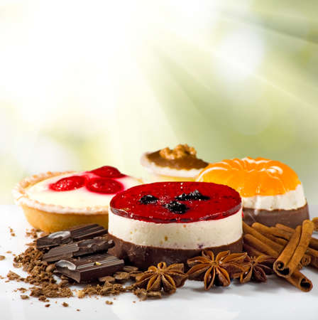 Image of different delicious cakes on a plate on a greenの写真素材