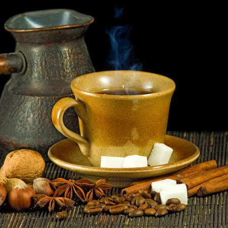 cup of coffee and spices on a black backgroundの写真素材