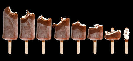 Isolated image of a bitten ice cream on a black background close-up